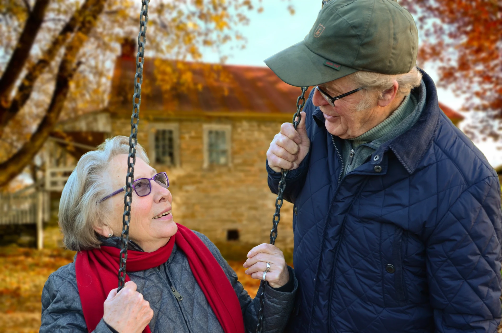 lady on a swing looking up at her husband